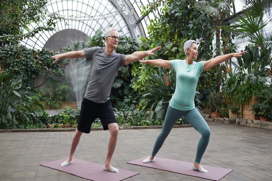 Two person doing yoga greenaty